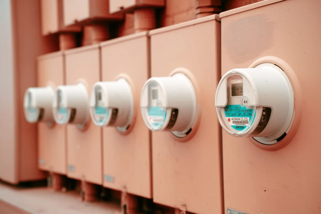 Row of residential electricity meters mounted on an exterior wall