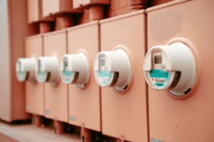 Row of residential electricity meters mounted on an exterior wall